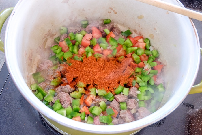 paprika spice on vegetables and beef in large pot