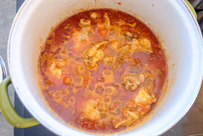chicken paprikash simmering in large pot on stove