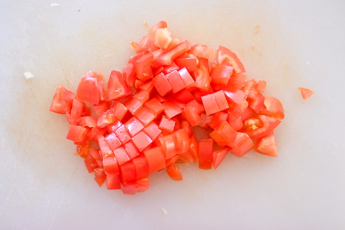 diced tomatoes in white cutting board