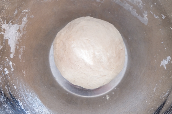 ball of dough in metallic mixing bowl