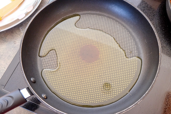 frying pan with oil on stove top