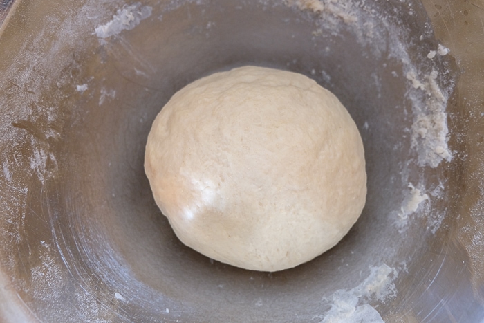 ball of dough in silver mixing bowl