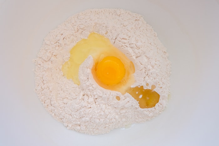 egg and flour in white mixing bowl