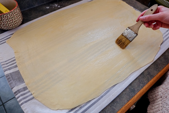 brushing apple strudel dough with butter paint brush