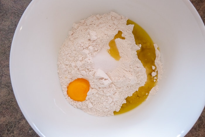 raw egg in bowl with flour and other ingredients