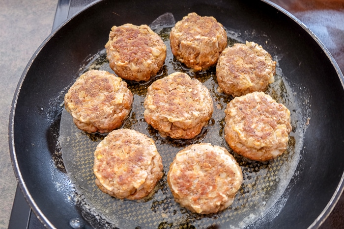 fried meatballs in black frying pan on stove top