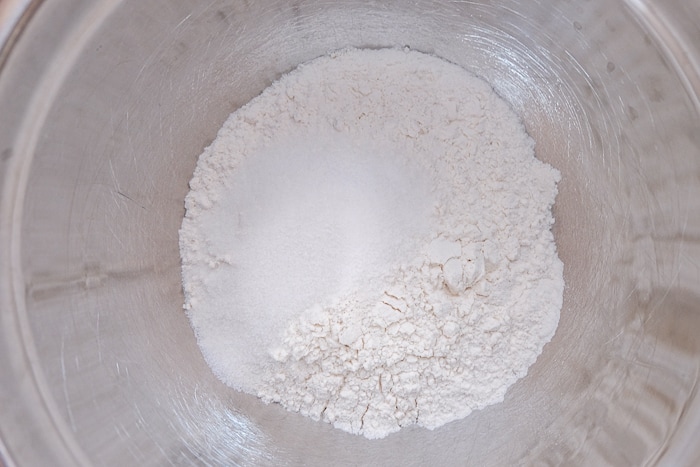 flour and sugar in silver mixing bowl on counter