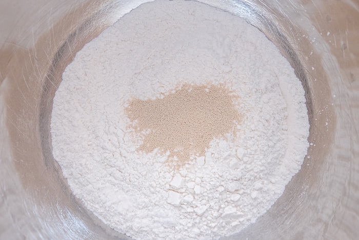 dry yeast with flour in silver mixing bowl