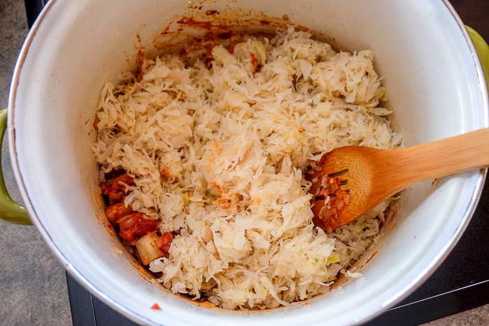 pot of sauerkraut with wooden spoon inside
