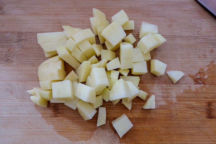 potatoes chopped up on wooden cutting board