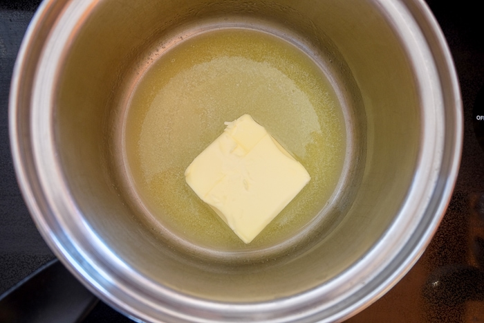 chunk of butter melting in silver pot