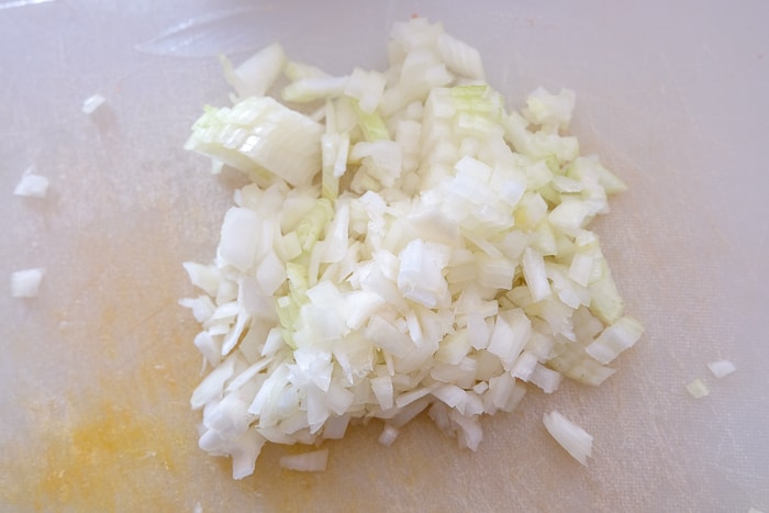 chopped onions on white cutting board
