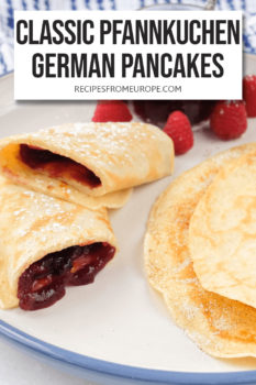 rolled up pancake with jam in the middle and folded pancake with cinnamon sugar in the middle on plate with text overlay saying "Classic Pfannkuchen German Pancakes"