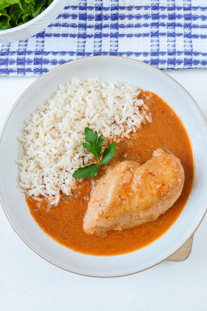 chicken with paprika and rice in broth in bowl