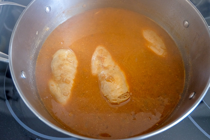 thickened chicken paprikash in silver pot on stove top