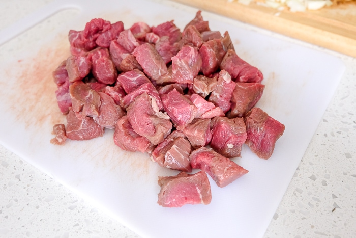 chopped pieces of raw beef on cutting board