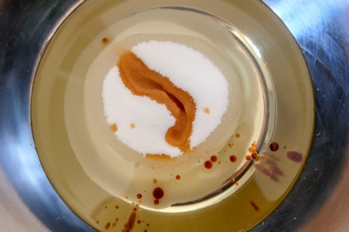 carrot cake ingredients in silver mixing bowl on counter