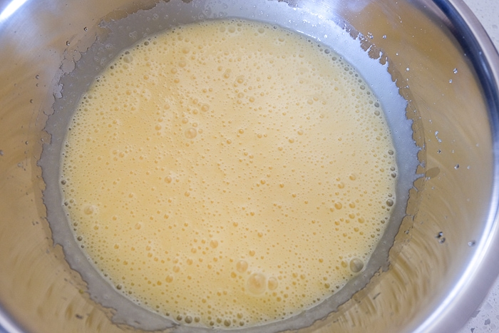 carrot cake batter in silver mixing bowl on counter