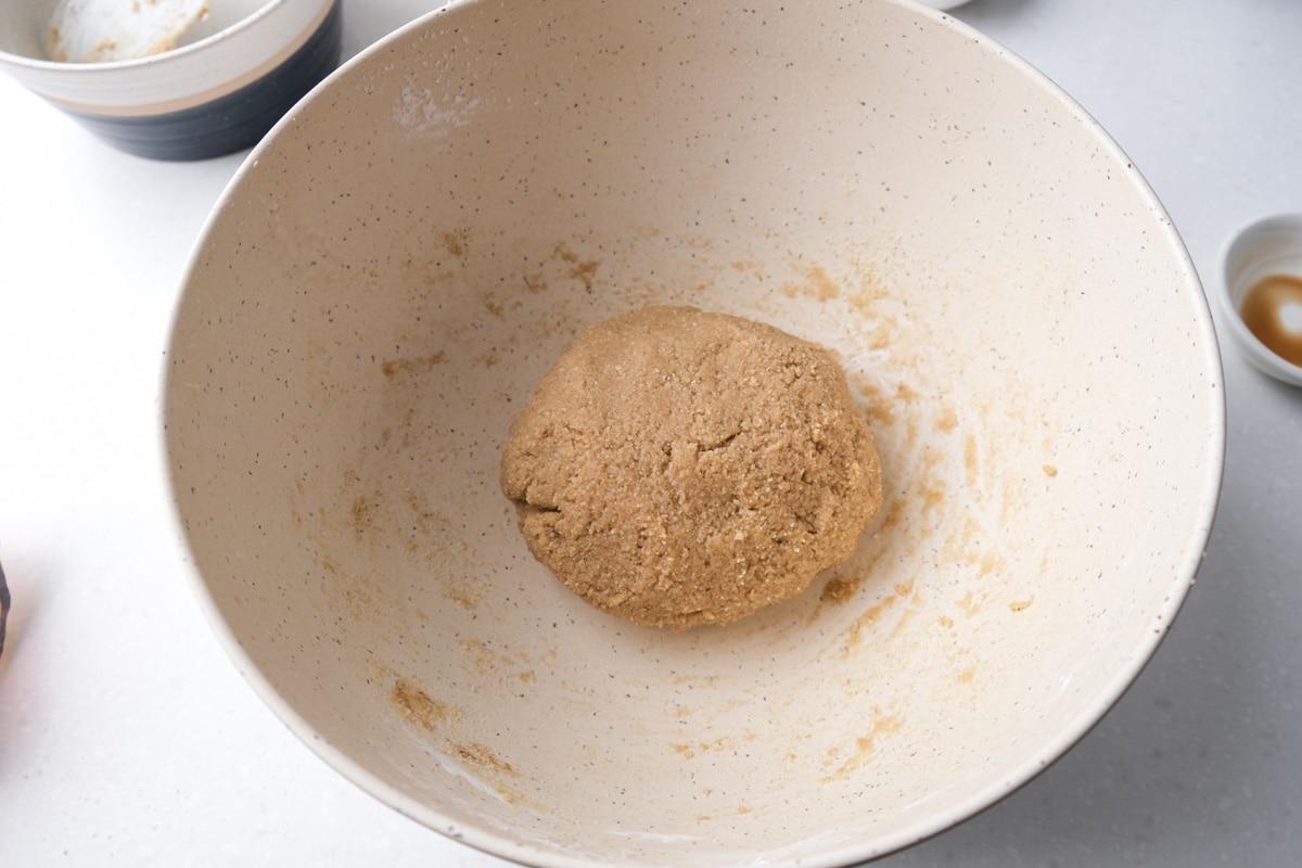 ball of cinnamon star cookie dough sitting in white mixing bowl.