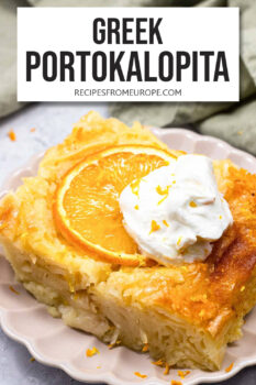 slice of orange cake on plate with whipped cream on top and text overlay "Greek Portokalopita".