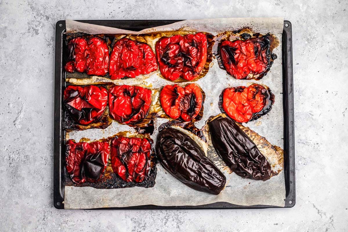 roasted red bell peppers and eggplant on baking sheet.