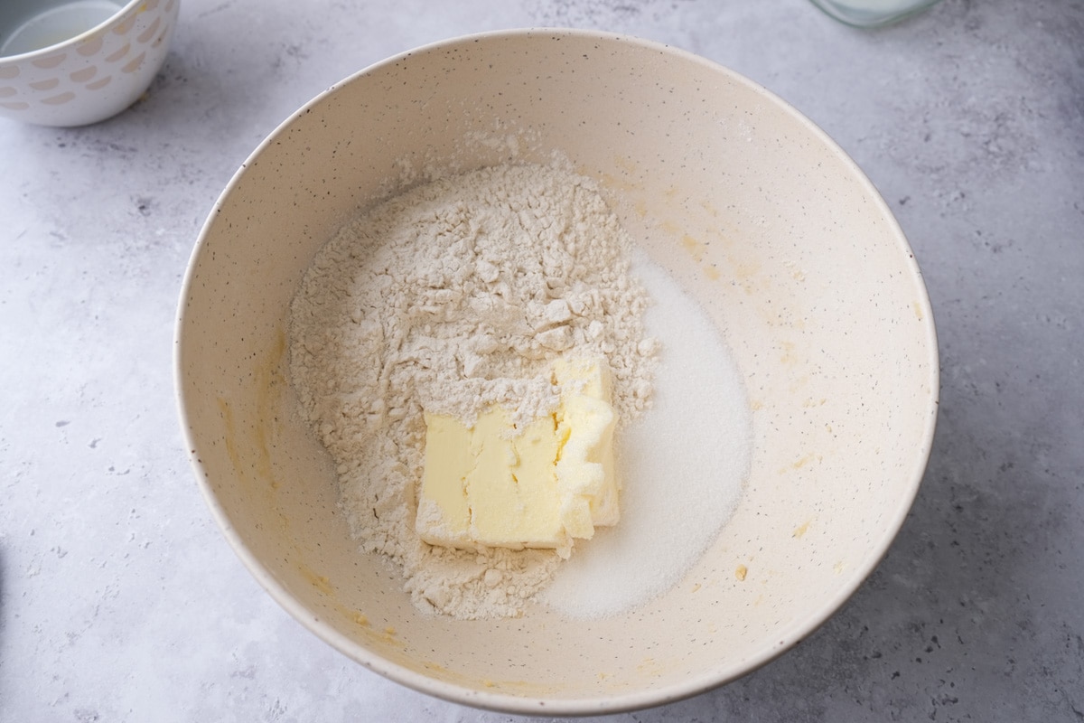 butter sugar and flour in white mixing bowl on counter.