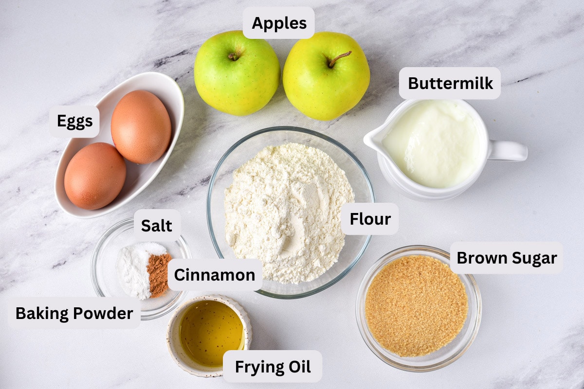 ingredients for russian apple pancakes on counter in bowls on labels.