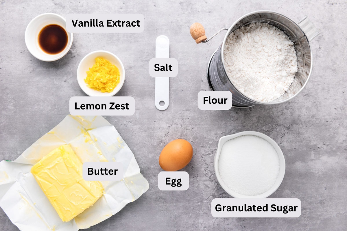 ingredients for dutch butter cake on grey counter in bowls with labels.