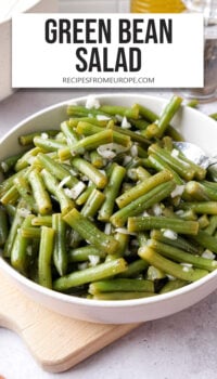 chopped green beans with onions in white serving bowl and text overlay "green bean salad".