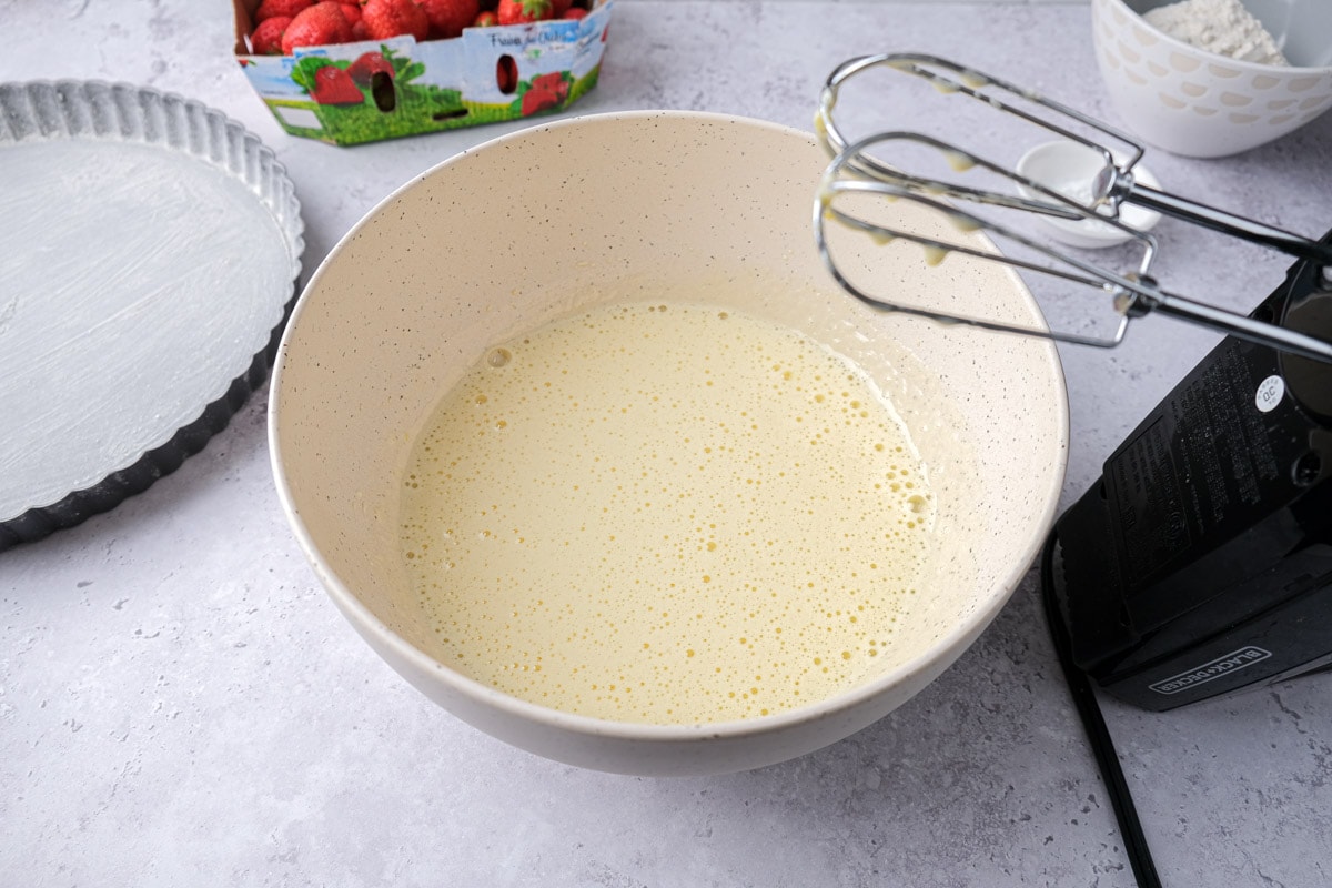 pale batter in white mixing bowl in counter.