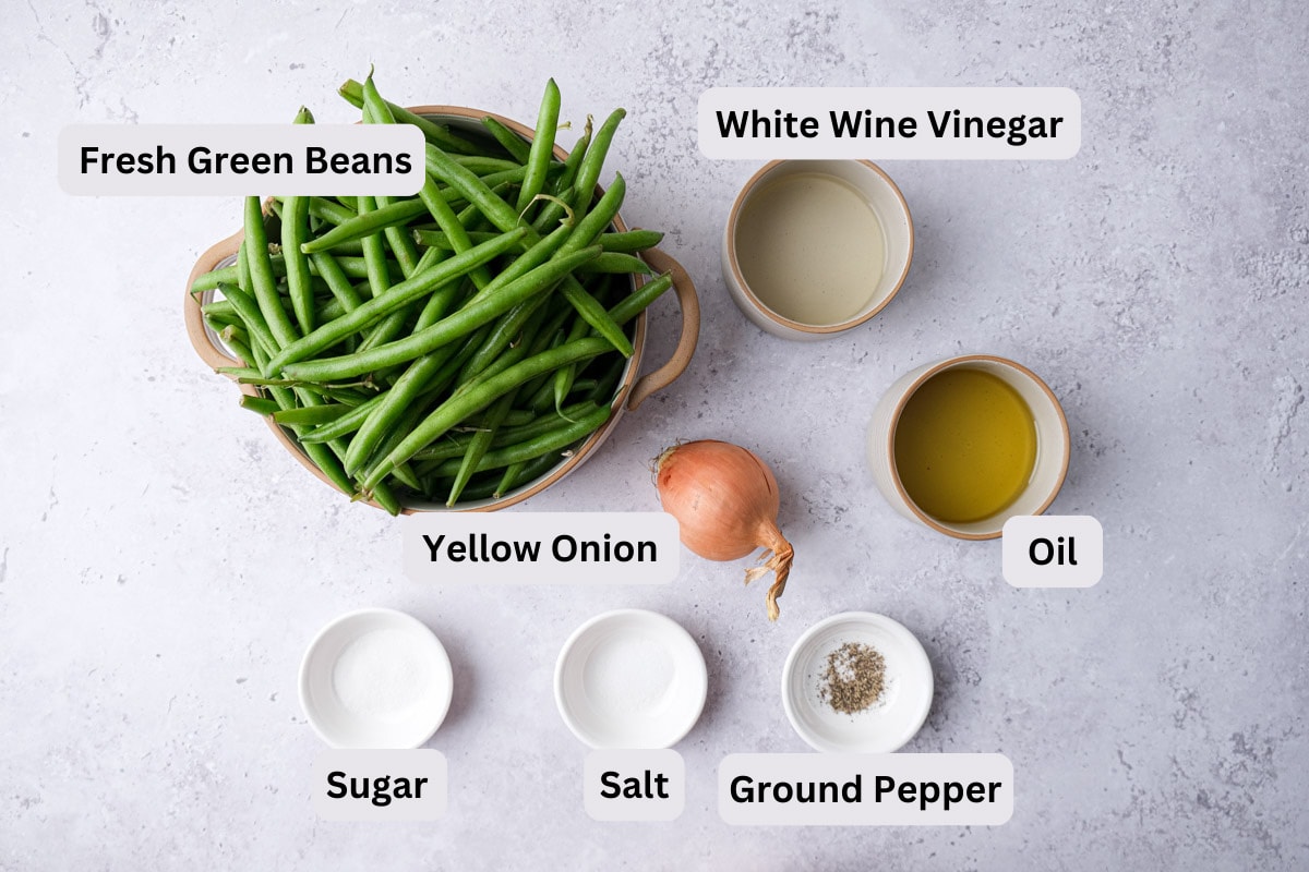 ingredients in bowls with labels on counter for german green bean salad.