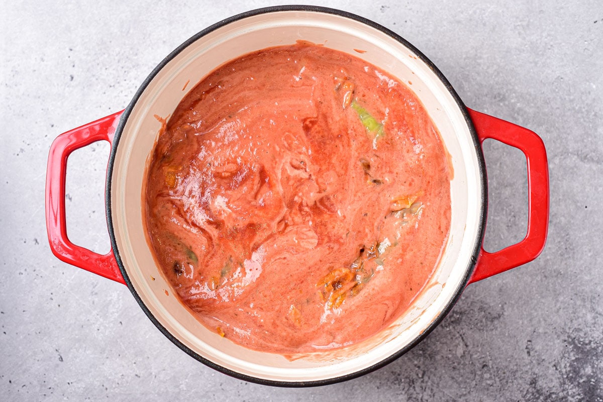 tomato sauce in large pot seen from above on counter top.
