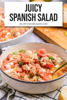salad with tuna, tomatoes and other ingredients in serving bowl with text overlay "juicy Spanish salad".
