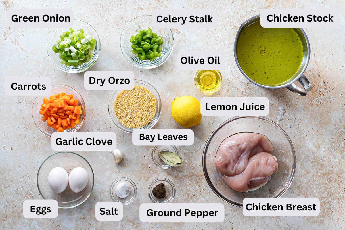 ingredients to make greek lemon chicken soup on counter in bowls with labels.
