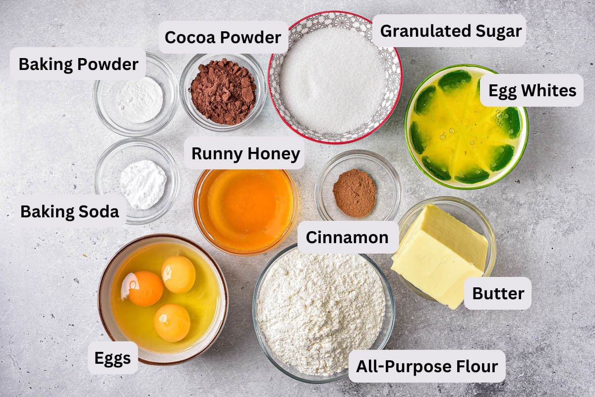 ingredients like eggs and flour in bowls on counter with labels.