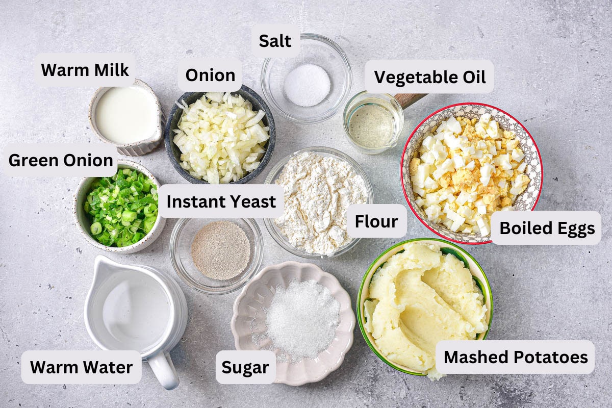 ingredients to make russian pirozhki like flour and potatoes on counter in bowls with labels.