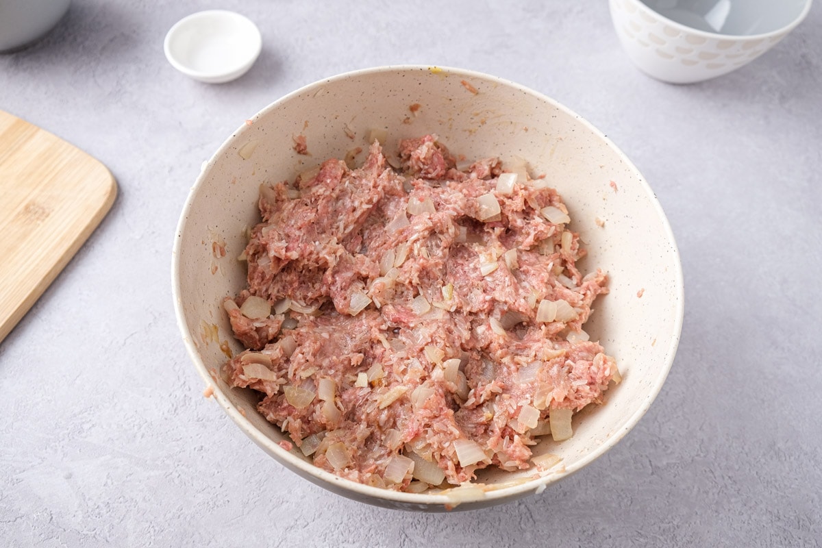 raw meat blend in white mixing bowl on counter top.