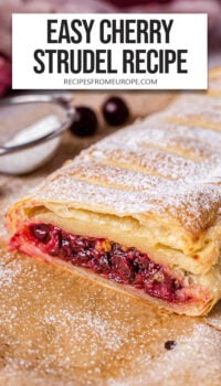 baked cherry strudel with powdered sugar on top on parchment paper with text overlay "easy cherry strudel recipe".