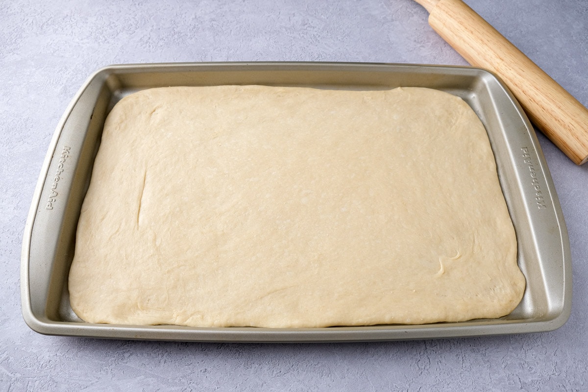 rectangle baking sheet covered in thin layer of dough.