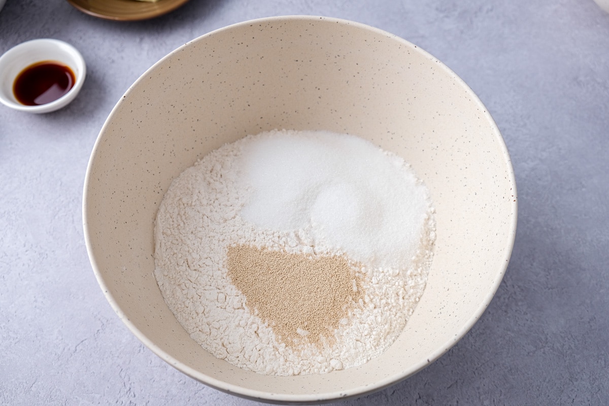 dry yeast sugar and flour in large mixing bowl on counter.