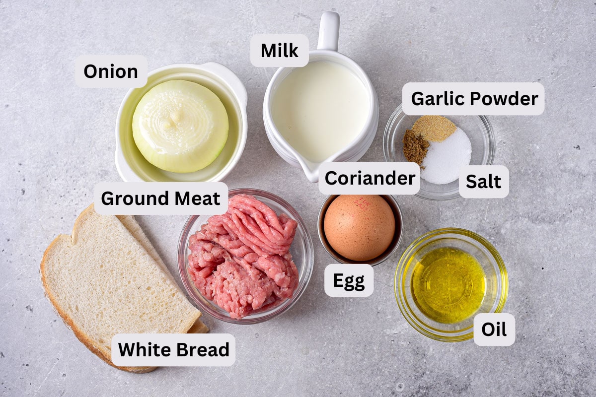 ingredients to make meat kotleti on counter in bowls with labels.