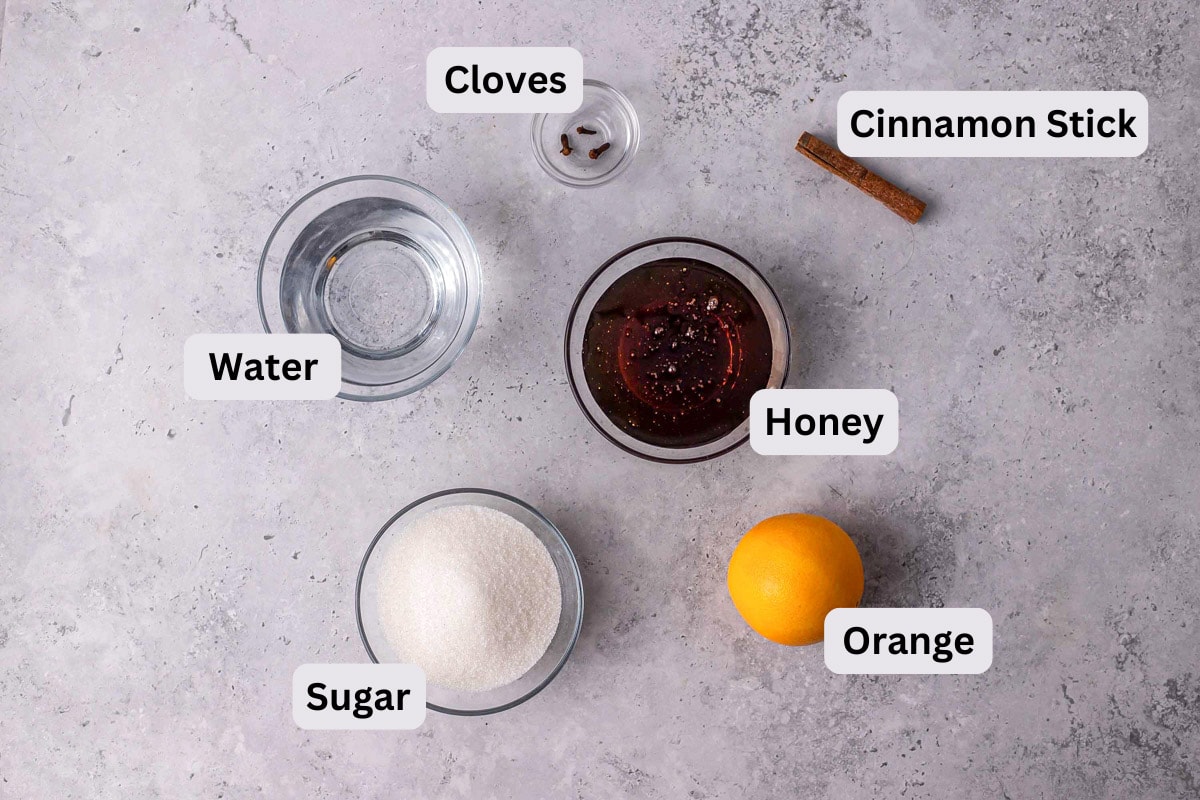 ingredients to make greek honey cookie syrup in bowls on counter.