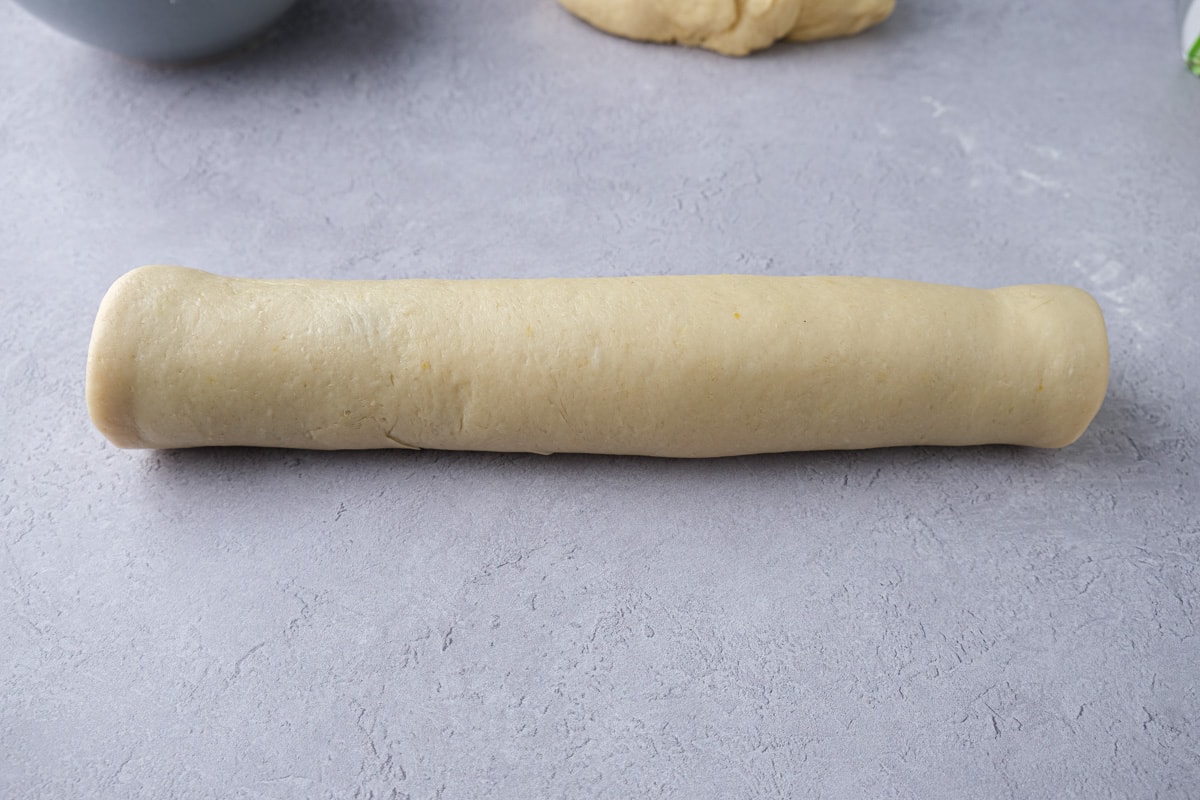 raw poppy seed roll sitting on counter top.