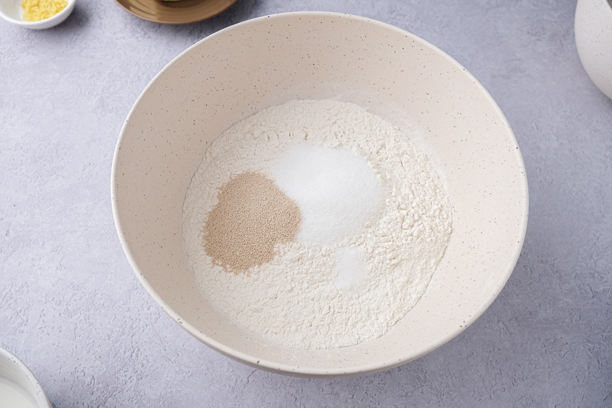 yeast salt and flour in mixing bowl on counter top.