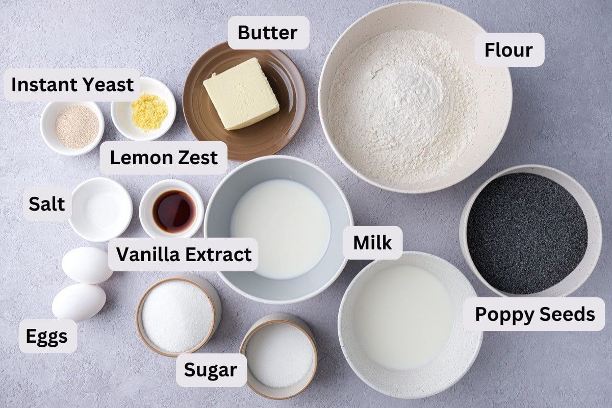 baking ingredients to make poppy seed roll on counter in bowls with labels.