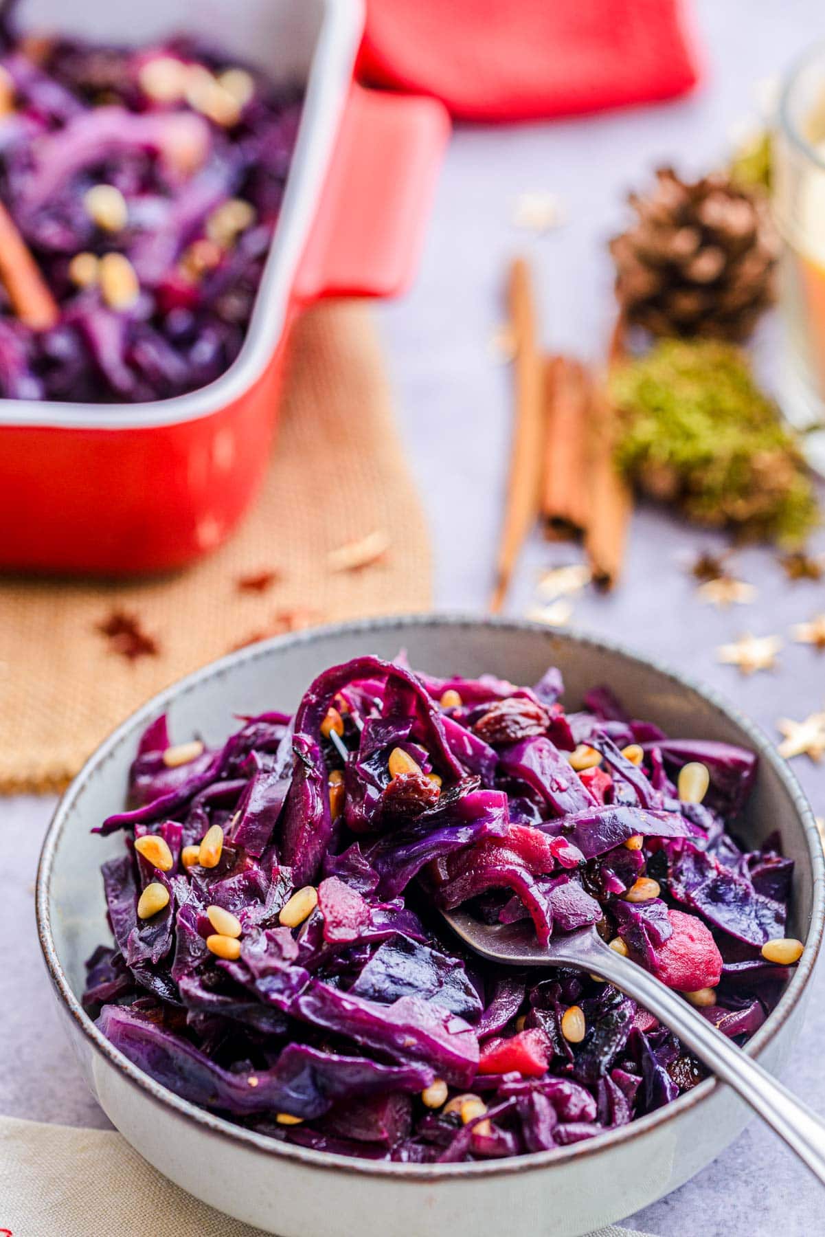 bowl filled with red cabbage with silver utensil sticking out.