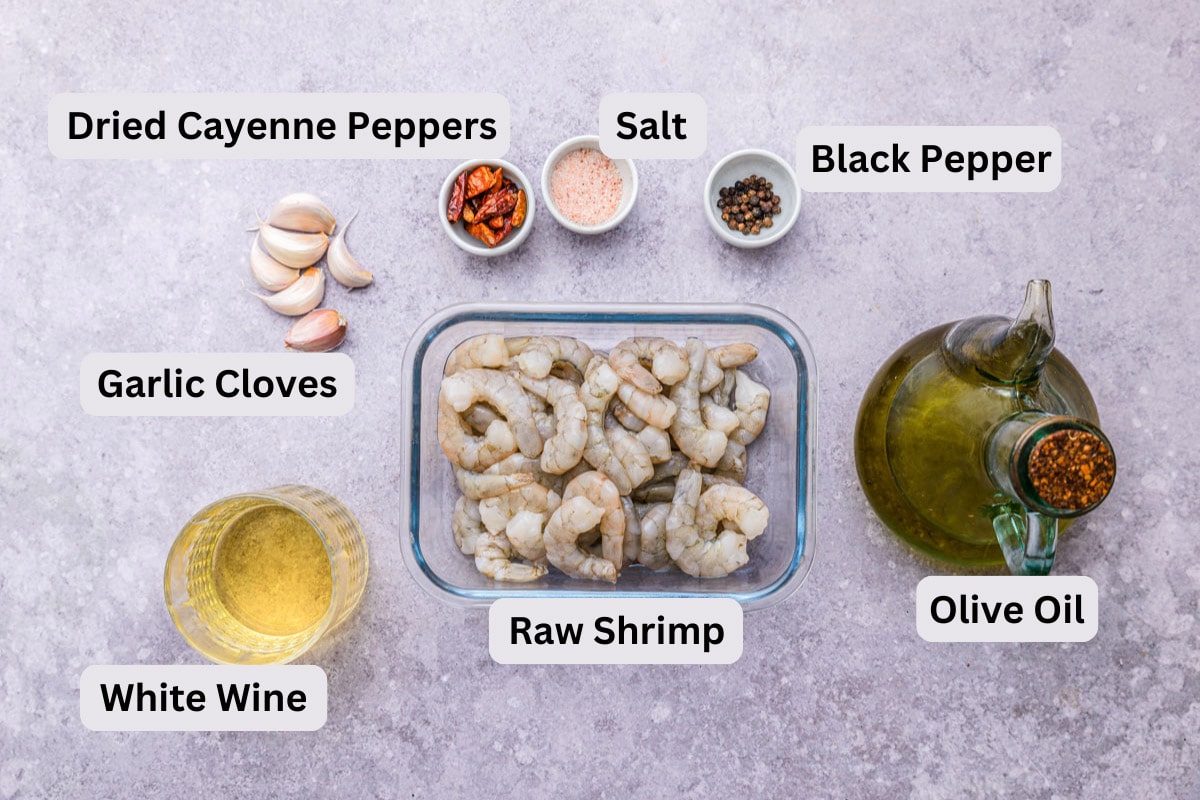 ingredients to make garlic shrimp in bowls on counter with labels.