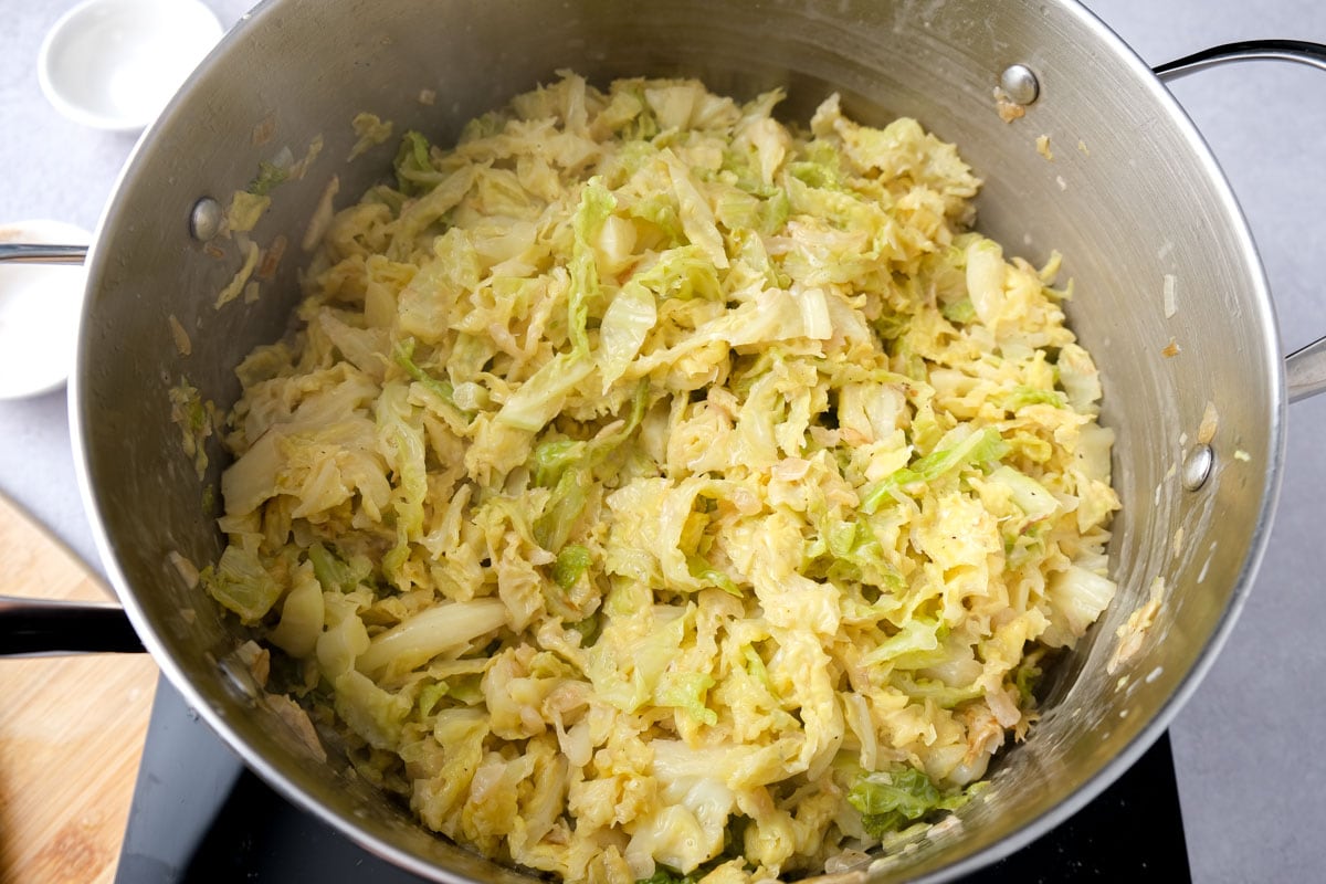 large pot of german creamed savoy cabbage sitting on hot plate on counter.