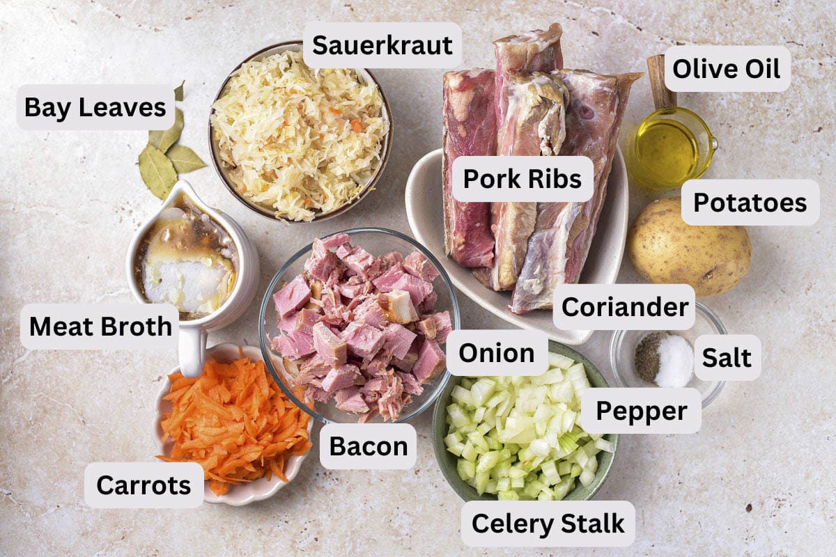 ingredients to make ukrainian sauerkraut soup in bowls on counter with labels.