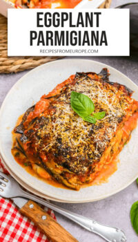 slice of eggplant parmesan on plate with text overlay "eggplant parmigiana".